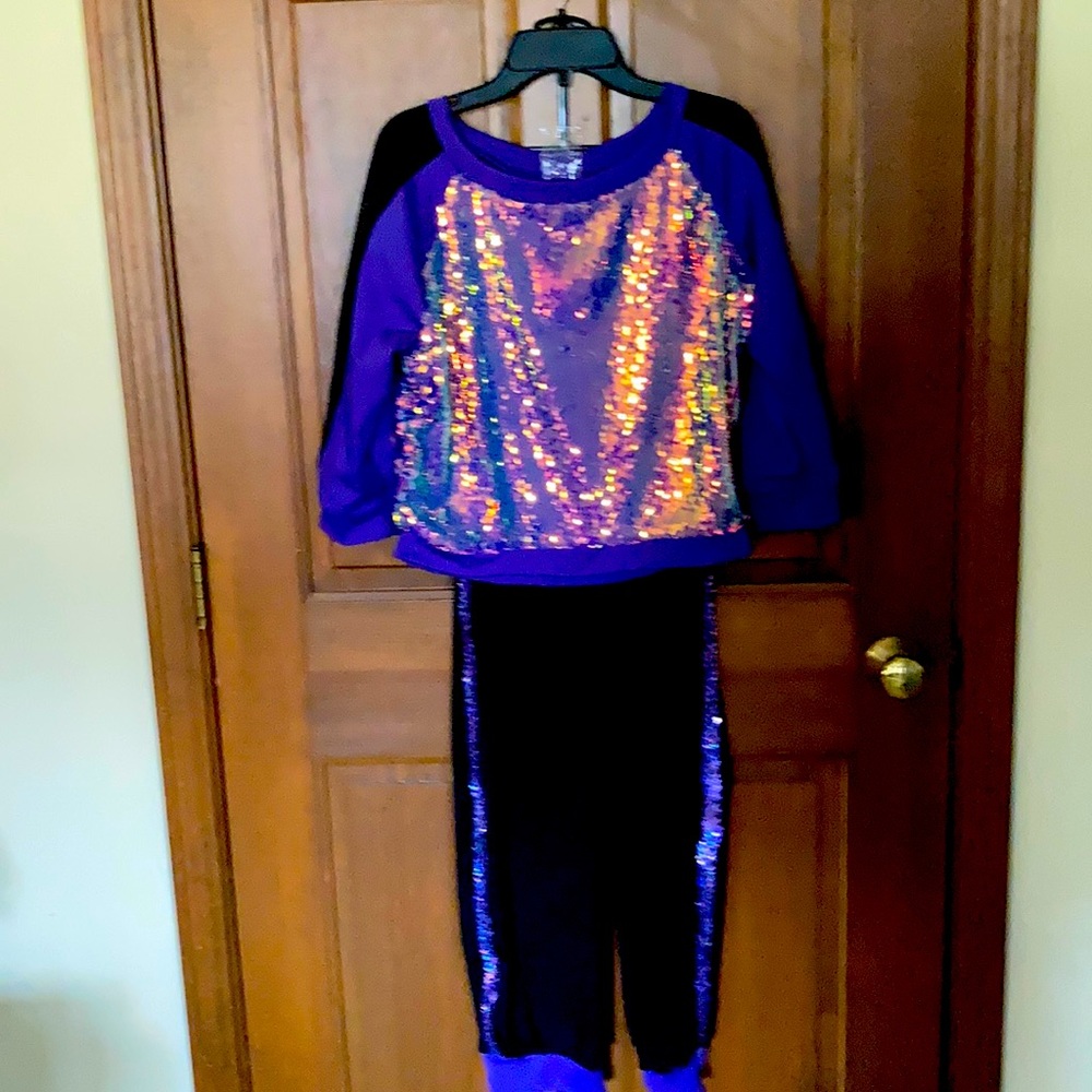 Purple and black 2-piece sequined dance outfit.